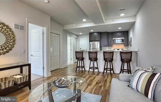 a living room with furniture and kitchen view