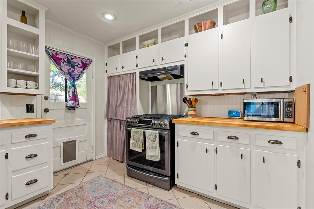 2216 Hermanson Drive Waco, TX 76710 - Photo 13 of 39 a kitchen with stainless steel appliances a stove a microwave and cabinets