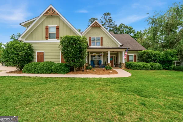 a front view of house with yard and green space