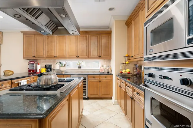a kitchen with stainless steel appliances granite countertop a sink stove and microwave