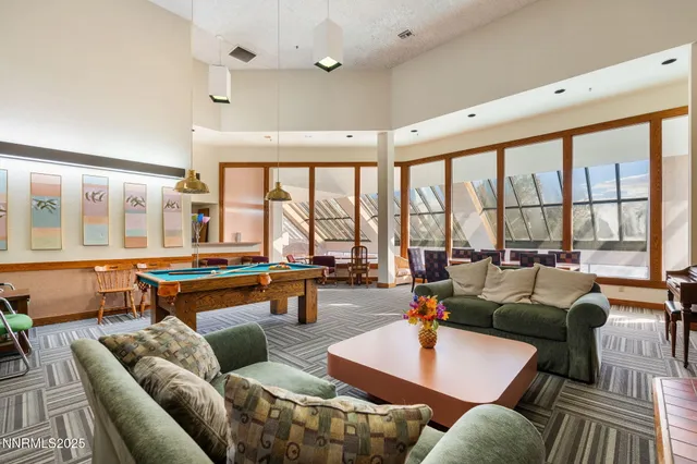 a living room with patio furniture and a fireplace