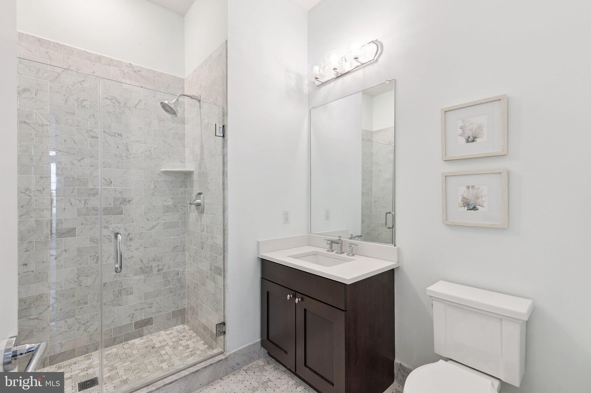 410 South Front Street, Unit 108 Philadelphia, PA 19147 - Photo 23 of 34 a bathroom with a sink a toilet and shower