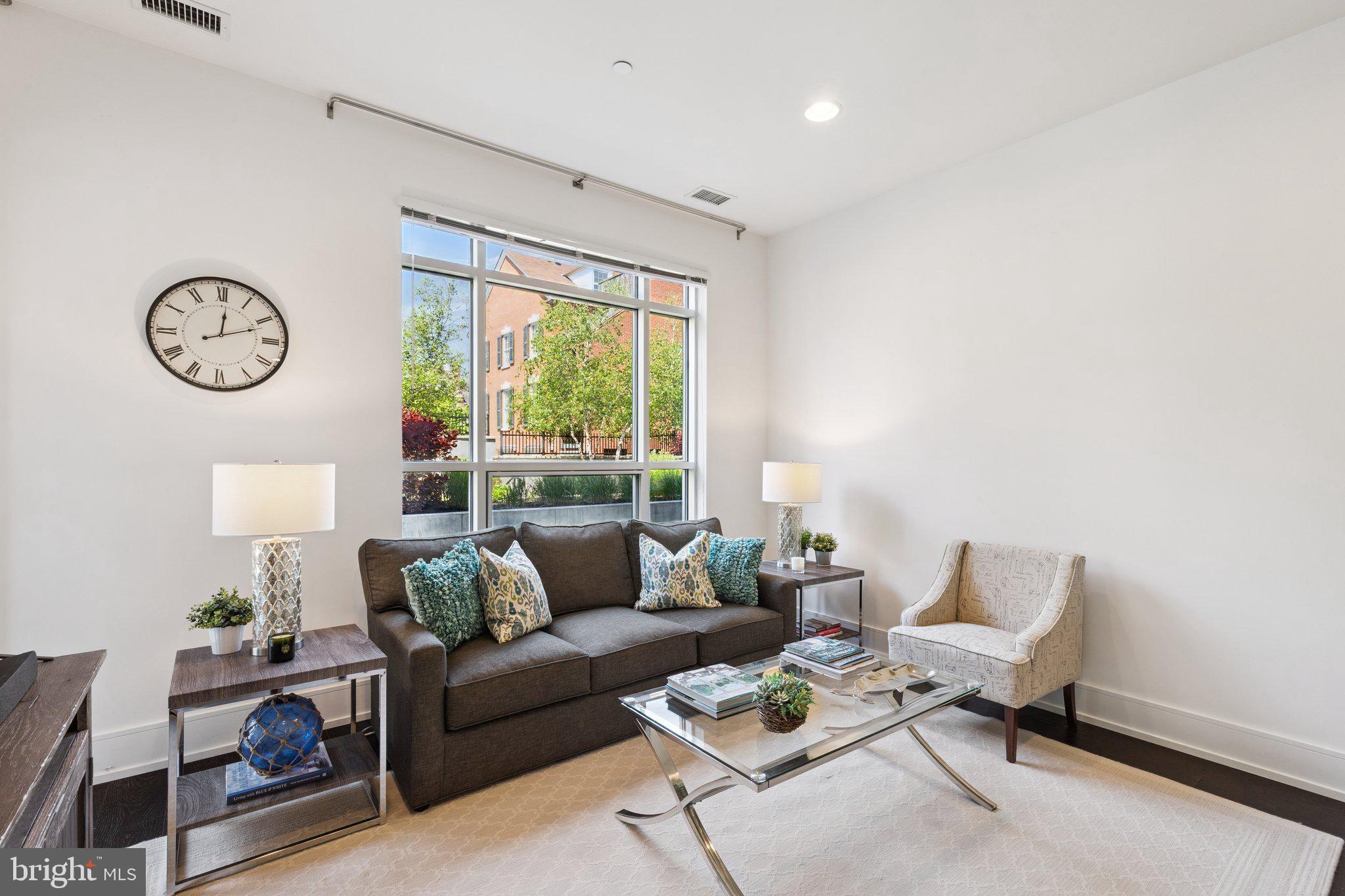 410 South Front Street, Unit 108 Philadelphia, PA 19147 - Photo 5 of 34 a living room with furniture a clock and a large window