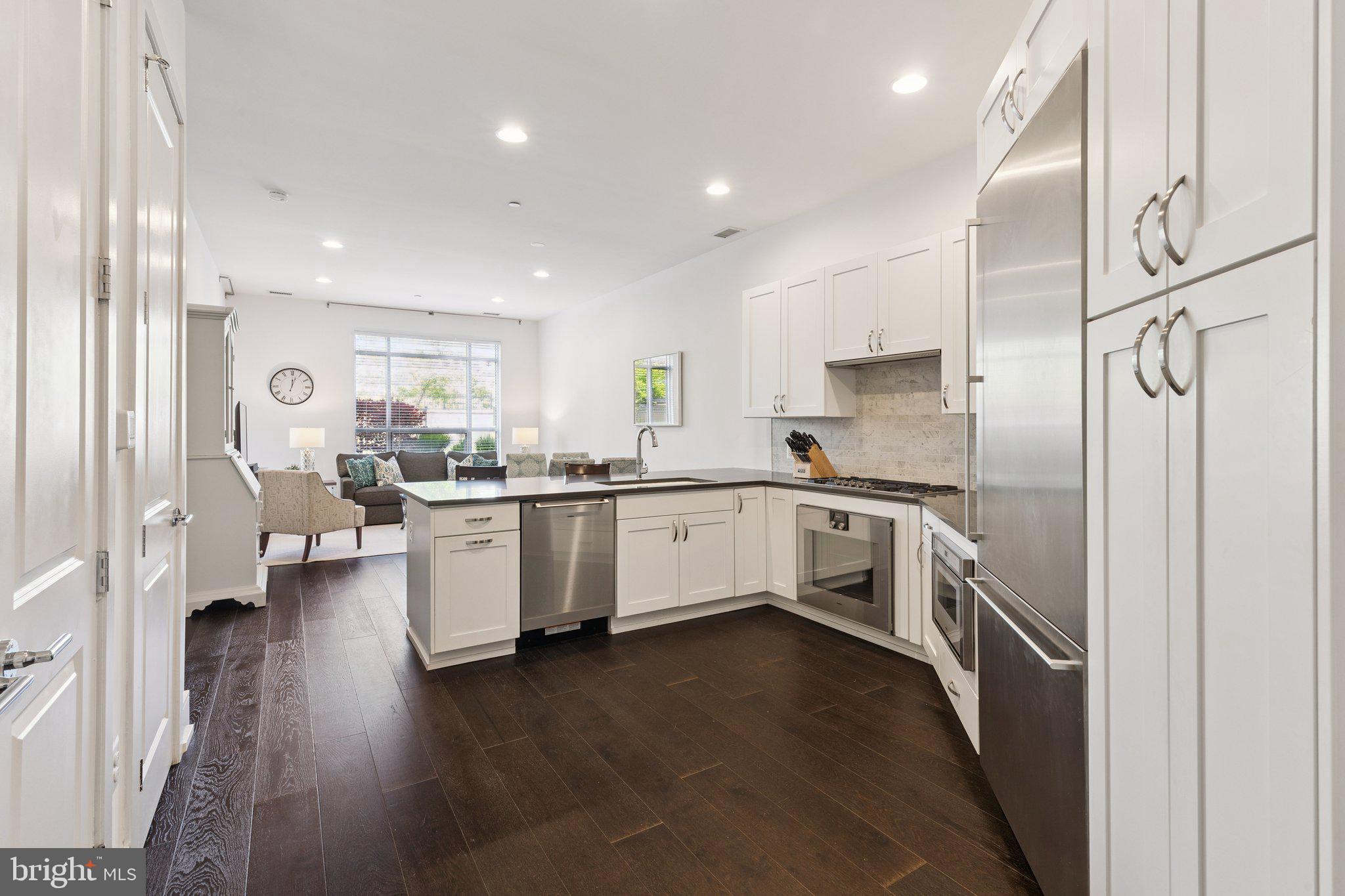 410 South Front Street, Unit 108 Philadelphia, PA 19147 - Photo 8 of 34 a kitchen with a refrigerator and white cabinets