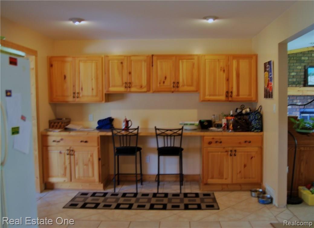 4704 Baldwin Road Metamora, MI 48455 - Photo 13 of 29 Extra cabinet and counter space with an eat-in area