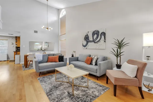 a living room with furniture and kitchen view