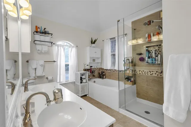 a bathroom with a sink a shower and a mirror