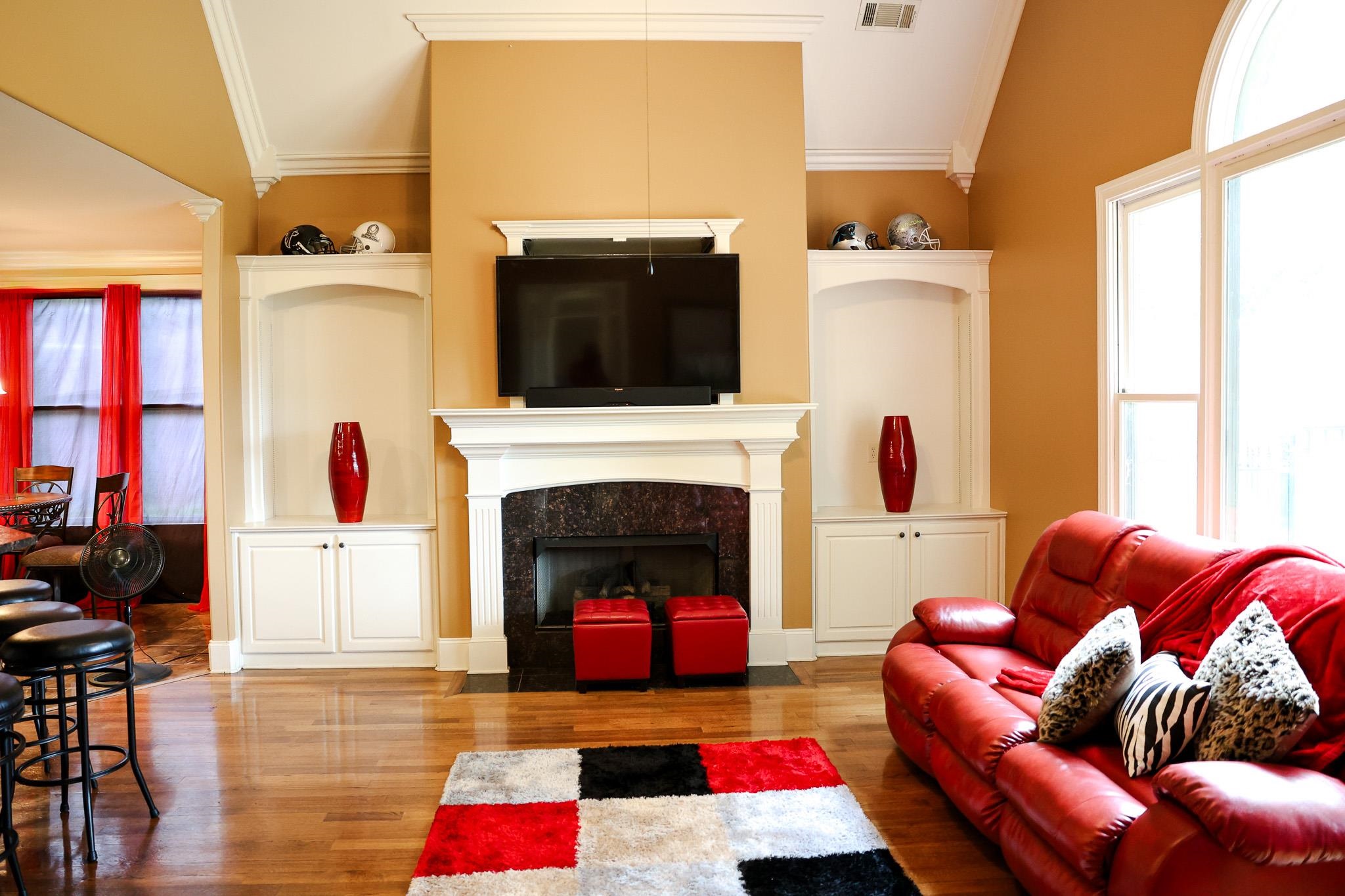 649 Ridge Springs Road Collierville, TN 38017 - Photo 18 of 35 Living area with wood finished floors, crown molding, and a fireplace