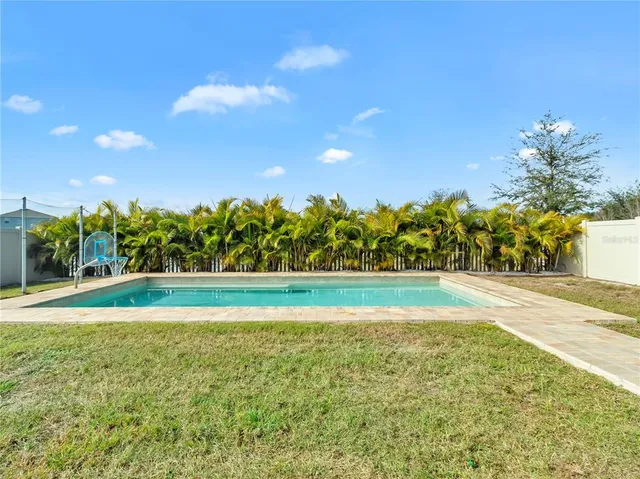a kitchen with stainless steel appliances granite countertop a table and chairs