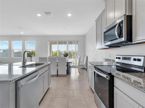 a kitchen with a sink and refrigerator