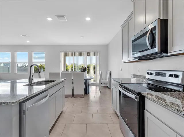 a kitchen with a sink and refrigerator