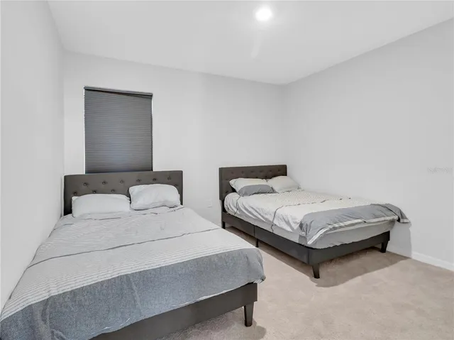 a bathroom with a granite countertop sink toilet and a mirror