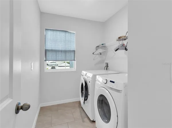 a bedroom with furniture and a wooden floor