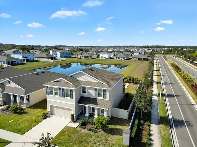 an aerial view of house with yard swimming pool and outdoor seating
