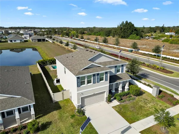 an aerial view of a house with a yard