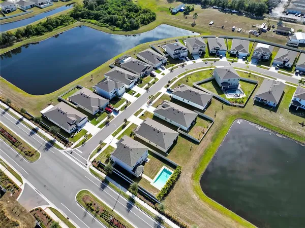 an aerial view of a swimming pool with outdoor seating