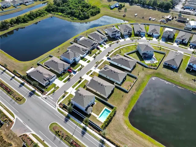 an aerial view of a swimming pool with outdoor seating