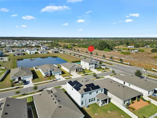 an aerial view of residential houses with outdoor space
