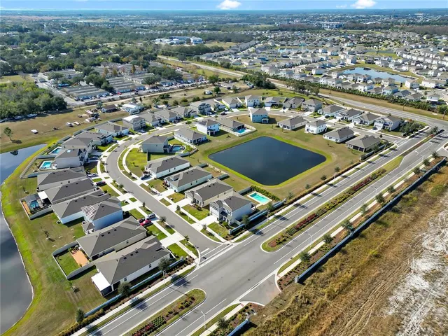 an aerial view of residential houses with outdoor space