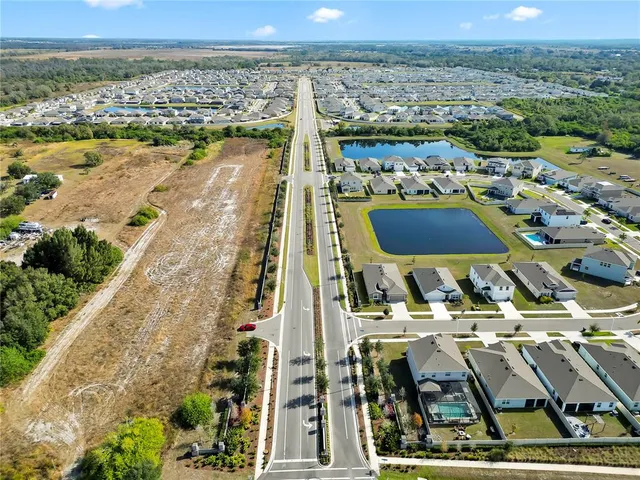 an aerial view of residential building and lake