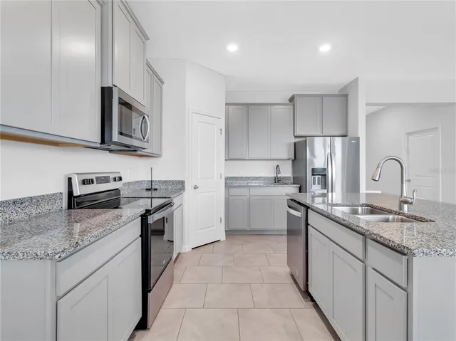 a living room with furniture a window and kitchen view