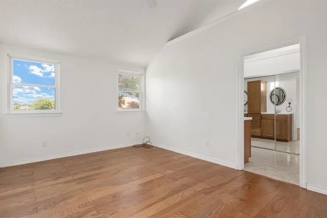 an empty room with windows and closet