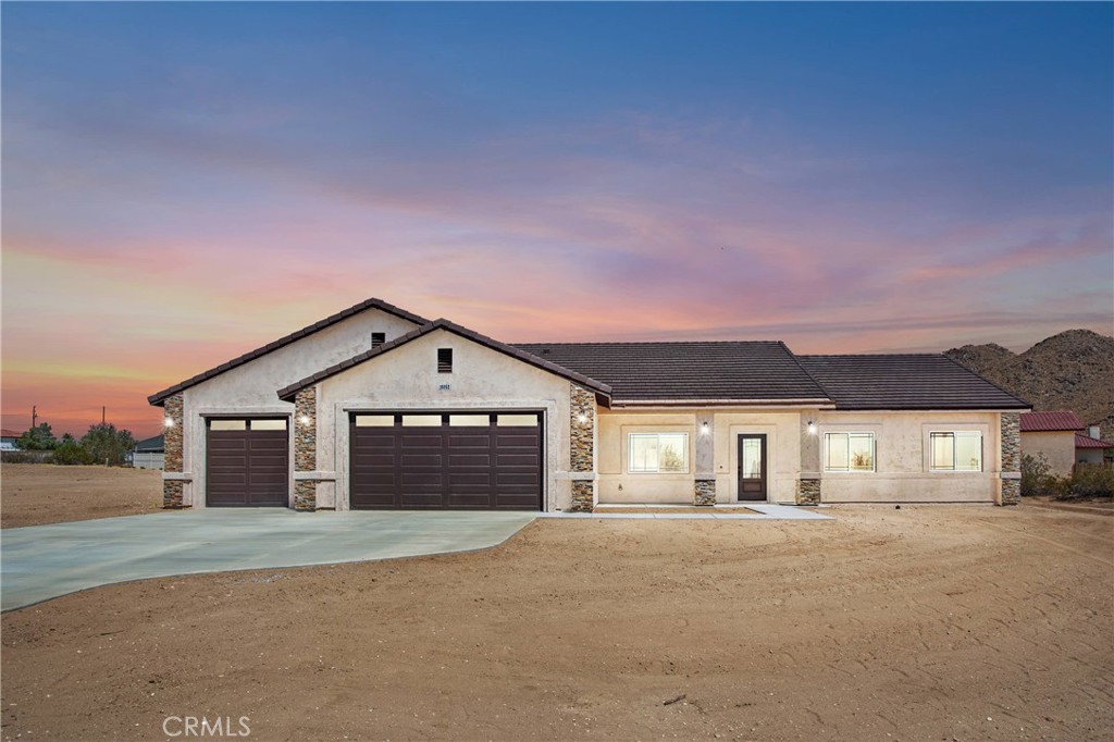 16052 Venango Road Apple Valley, CA 92307 - Photo 1 of 1 a front view of a house with a yard and garage