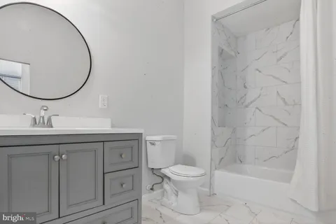 a view of an empty room with a window and a fan