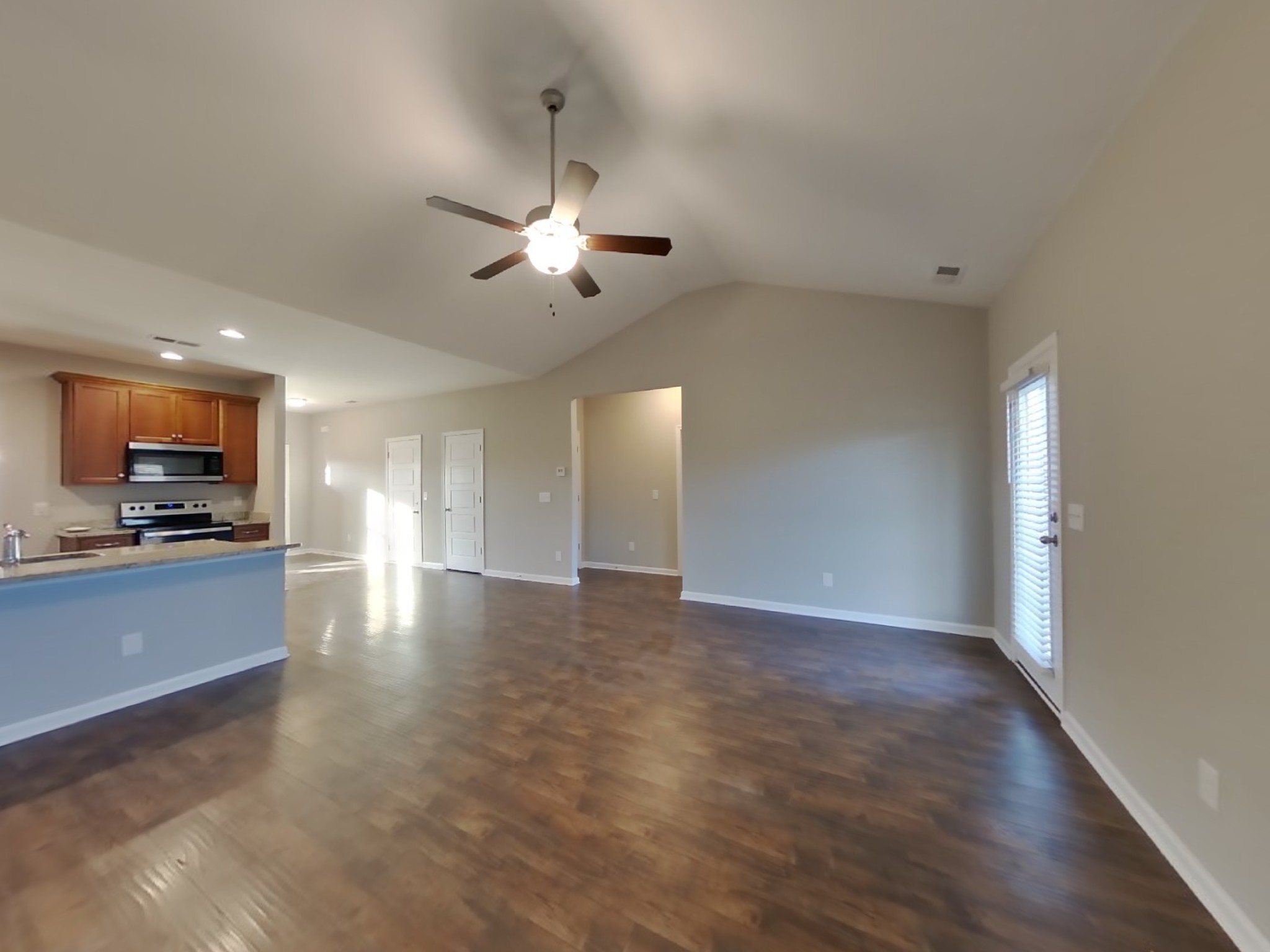 815 Ellyson Drive Spring Hill, TN 37174 - Photo 2 of 16 wooden floor in an empty room with a kitchen