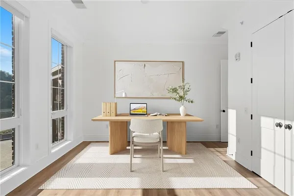 a bedroom with a bed and a potted plant