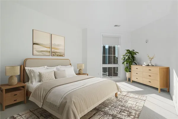 a view of a bedroom with wooden floor and windows