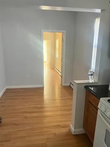 a view of walk in closet with window and wooden floor