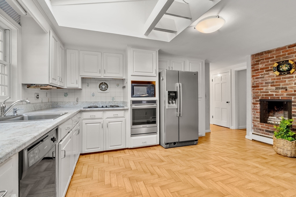 31 White Road Wayland, MA 01778 - Photo 11 of 36 a kitchen with stainless steel appliances granite countertop a stove cabinets and a refrigerator