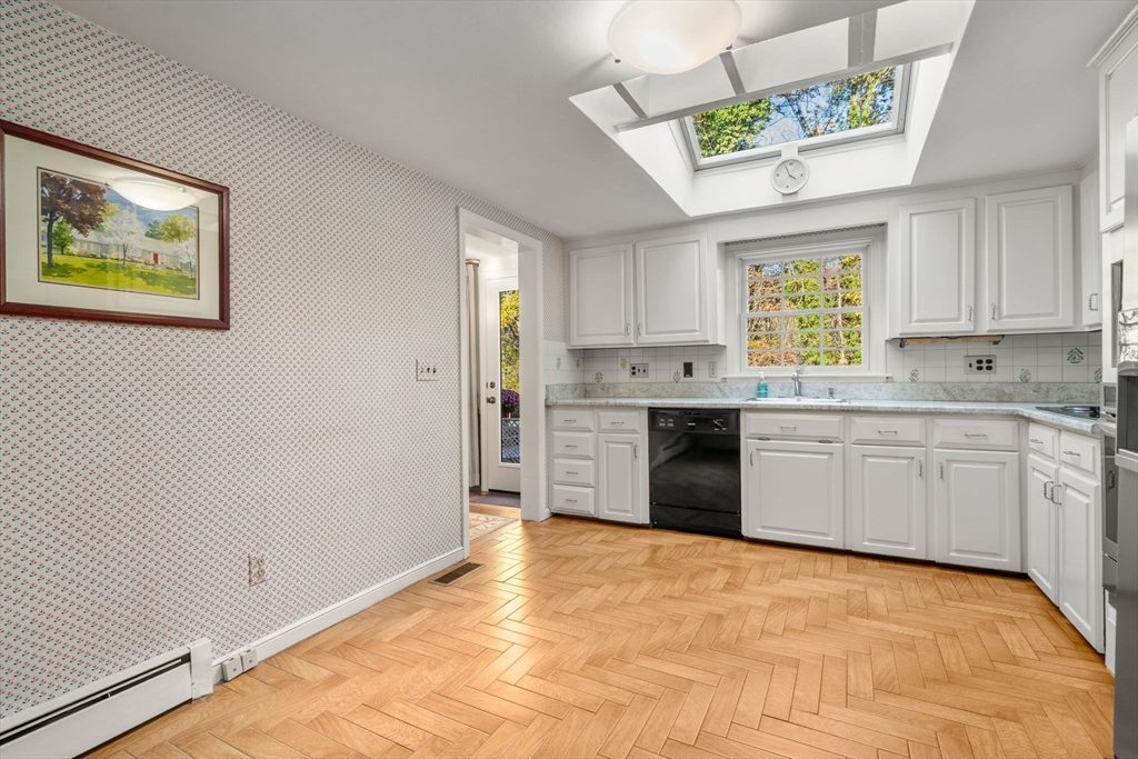 31 White Road Wayland, MA 01778 - Photo 13 of 36 a kitchen with stainless steel appliances white cabinets a sink and a window