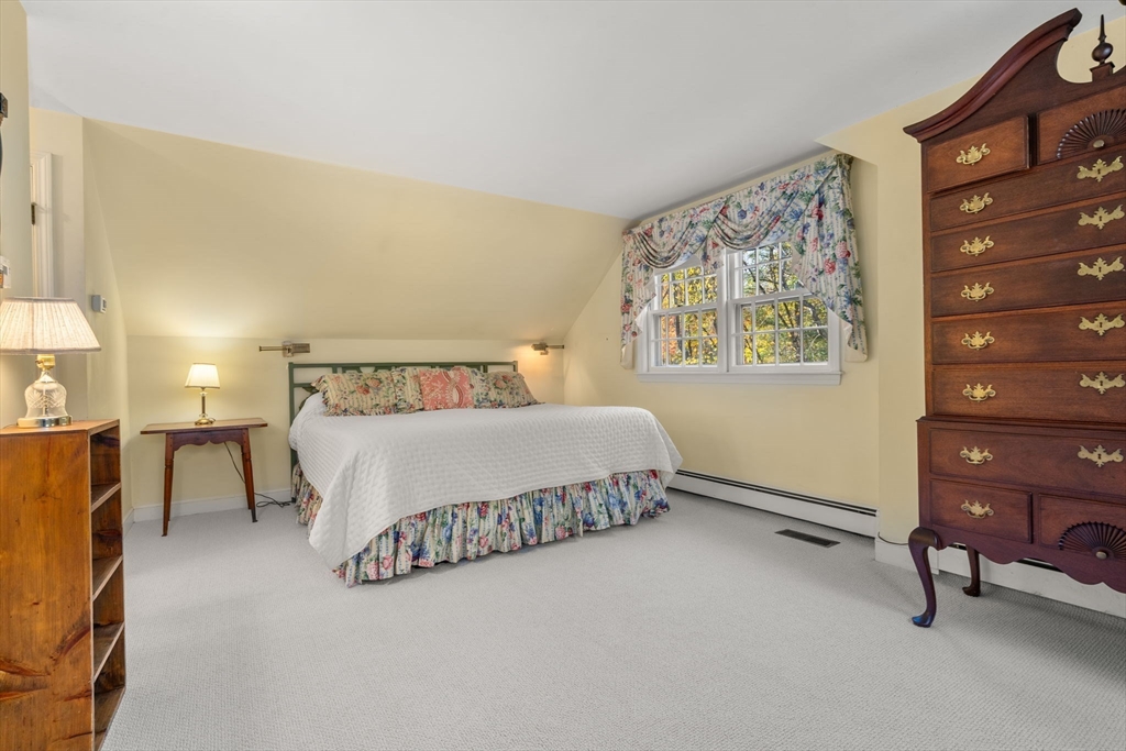 31 White Road Wayland, MA 01778 - Photo 27 of 36 a spacious bedroom with a bed dresser and a window