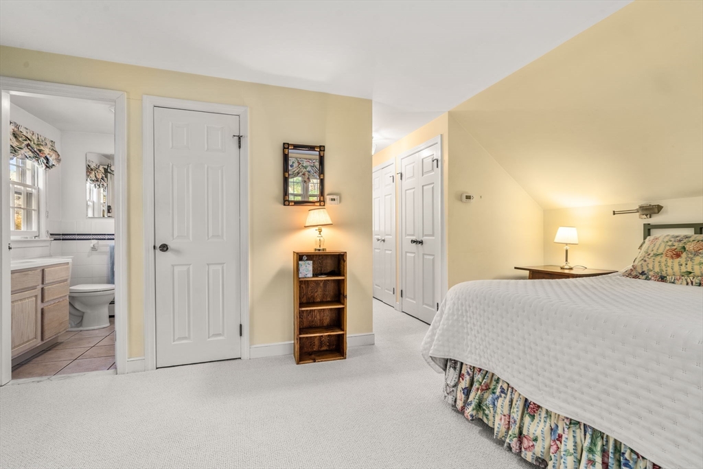 31 White Road Wayland, MA 01778 - Photo 28 of 36 a bedroom with a bed and a lamp