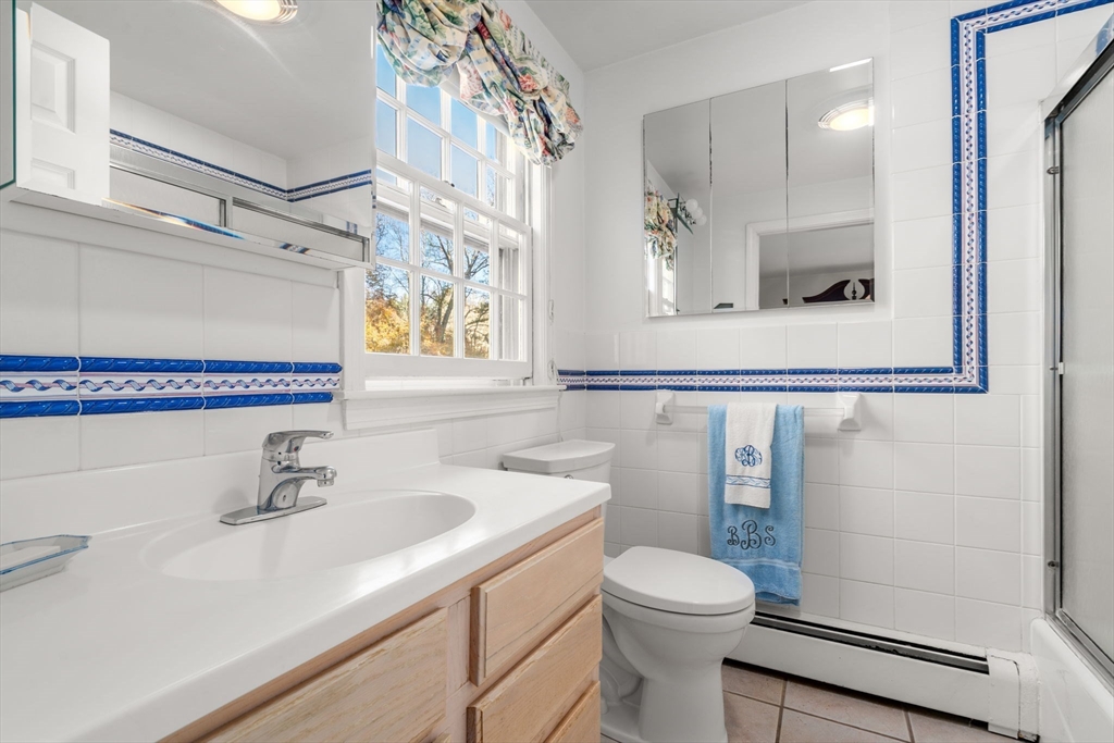 31 White Road Wayland, MA 01778 - Photo 29 of 36 a bathroom with a sink a toilet and shower