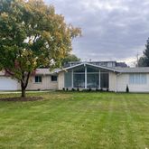 a big house with a big yard and large trees
