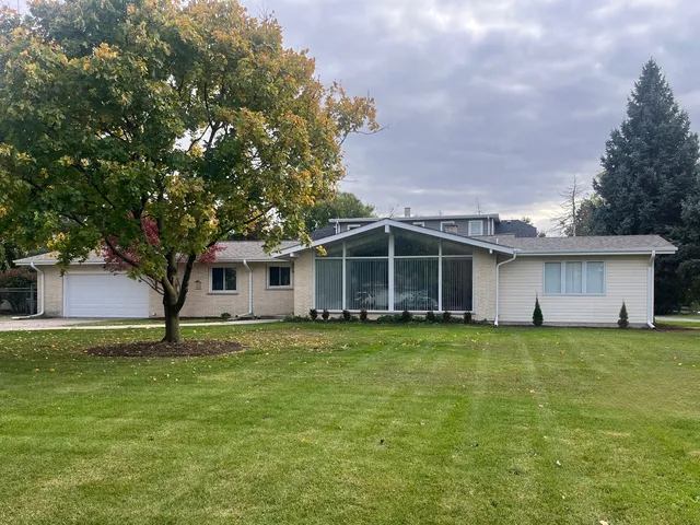 a big house with a big yard and large trees