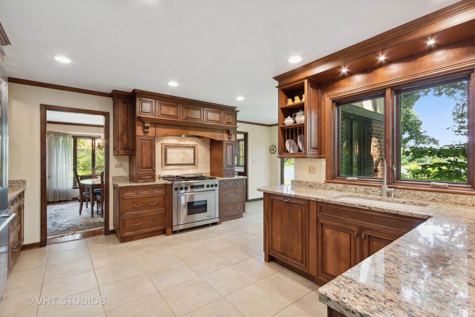 395 North Valley Road Barrington, IL 60010 - Photo 9 of 45 a large kitchen with kitchen island granite countertop a large window and stainless steel appliances