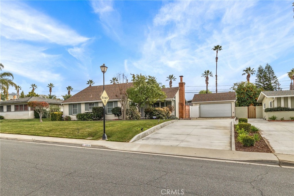 3018 Cimarron Road Riverside, CA 92506 - Photo 1 of 1 a view of a house next to a yard with big trees