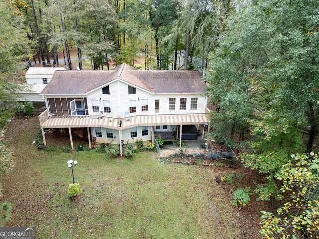 a aerial view of a house with a yard table and chairs