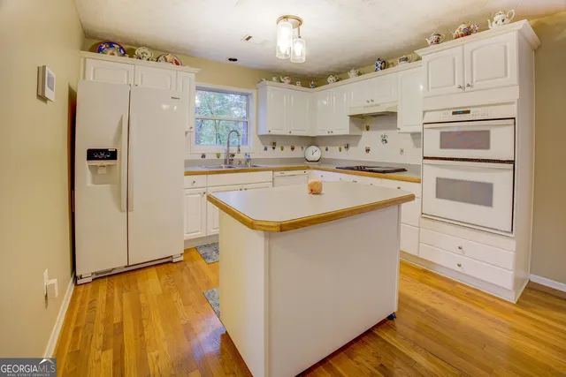 a balcony with wooden floor and fence