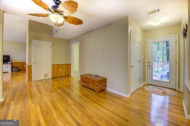 a living room with fireplace furniture and a rug