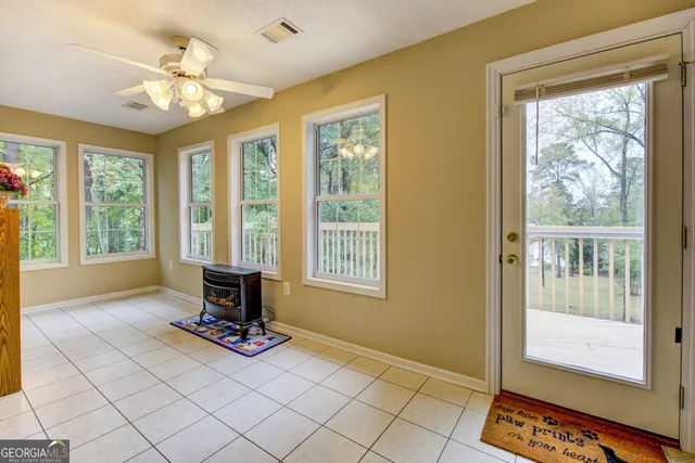 a view of an empty room with a ceiling fan and a window