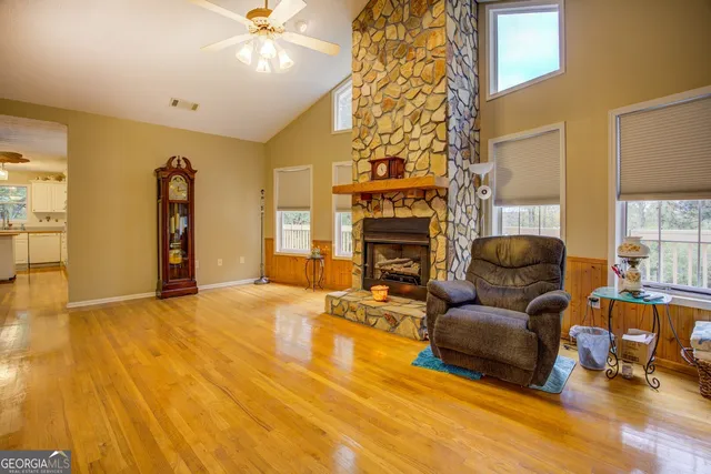 an empty room with a window and a ceiling fan
