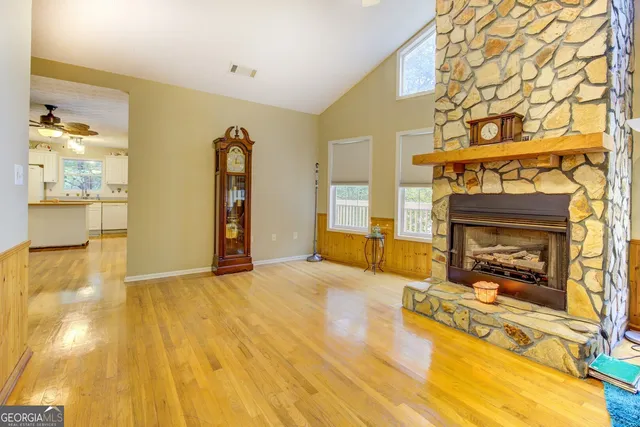 a living room with a black white checkered floor with couches chair and a coffee table
