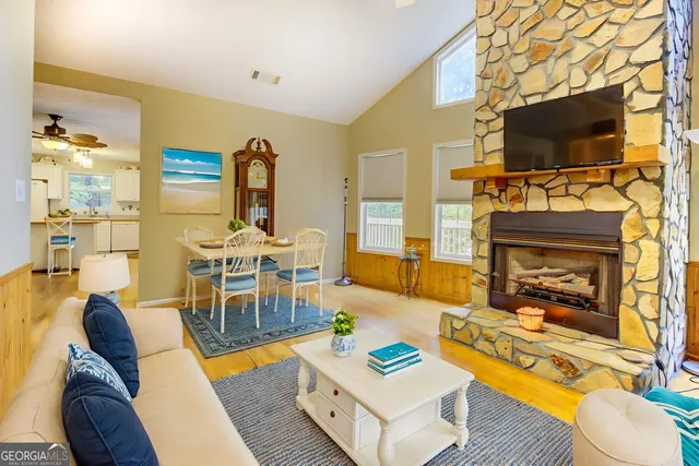a living room with a black white checkered floor with couches chair and a coffee table