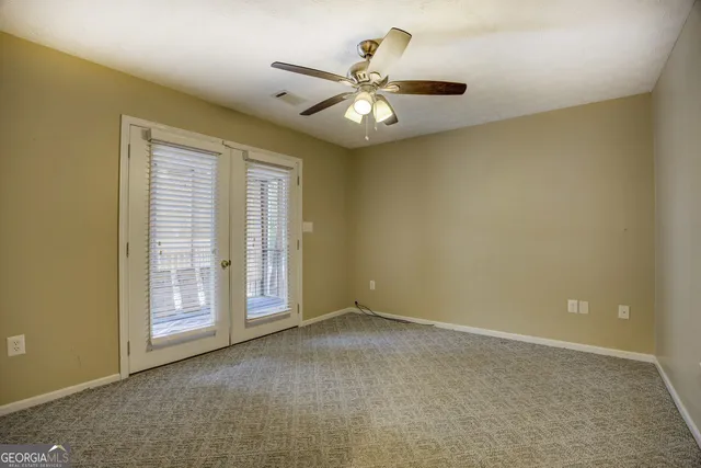a view of a house with a yard balcony and tree