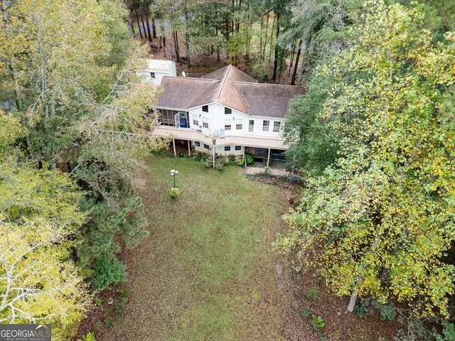 an aerial view of a house with a yard